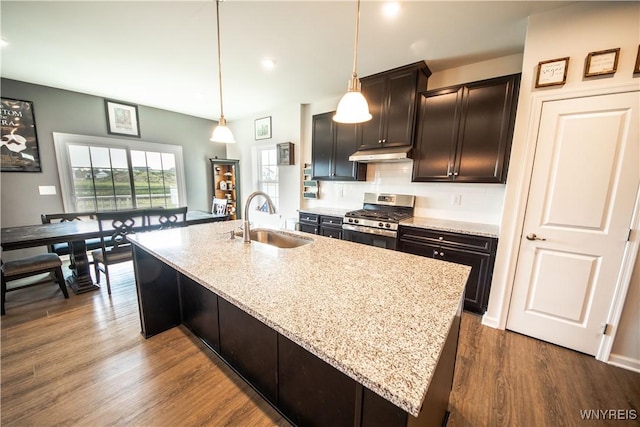 510 Limestone Ct, Grand Island, NY 14072 - kitchen featuring stainless steel range with gas cooktop, under cabinet range hood, light stone countertops, a kitchen island with sink, and dark wood-style flooring