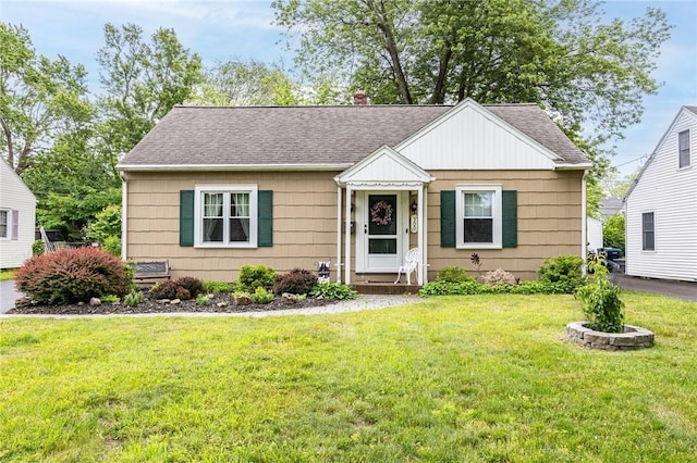 309 Brandon Rd, Irondequoit, NY 14622 - bungalow-style house with roof with shingles, a front lawn, and a chimney