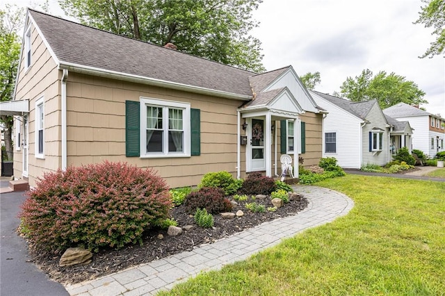 309 Brandon Rd, Irondequoit, NY 14622 - bungalow-style house with a front lawn and a shingled roof