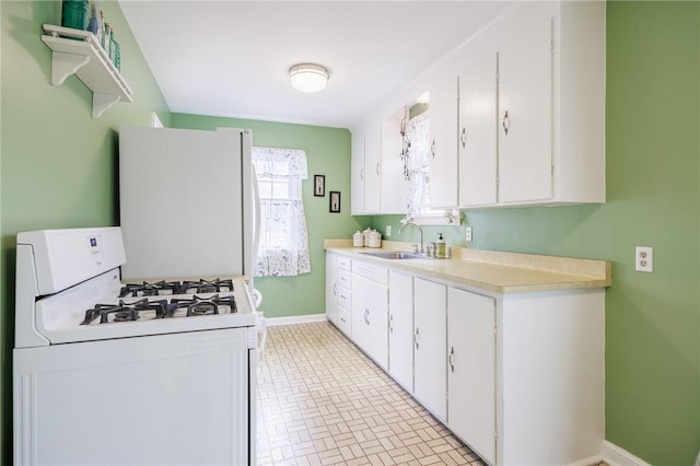 309 Brandon Rd, Irondequoit, NY 14622 - kitchen featuring white gas range oven, white cabinetry, and light countertops