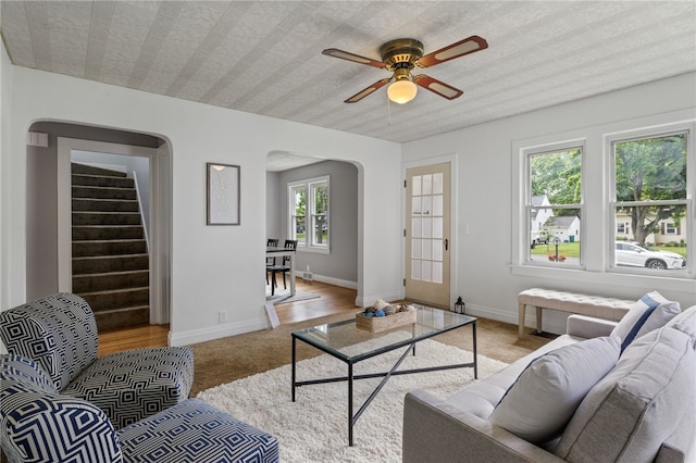 316 Walzer Rd, Irondequoit, NY 14622 - living room with arched walkways, light carpet, a ceiling fan, and stairway