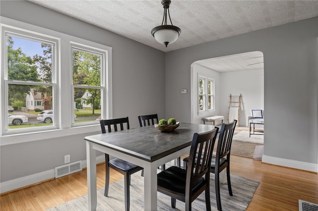 316 Walzer Rd, Irondequoit, NY 14622 - dining room with arched walkways and light wood-style flooring