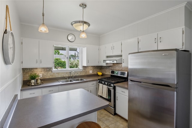 316 Walzer Rd, Irondequoit, NY 14622 - kitchen featuring stainless steel appliances, under cabinet range hood, dark countertops, white cabinetry, and ornamental molding