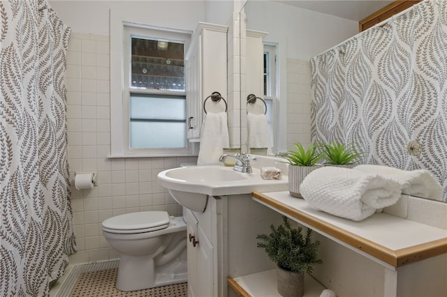 316 Walzer Rd, Irondequoit, NY 14622 - bathroom with tile walls, vanity, tile patterned floors, and curtained shower