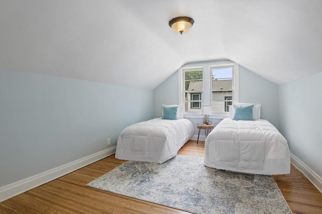 316 Walzer Rd, Irondequoit, NY 14622 - bedroom with wood finished floors and vaulted ceiling