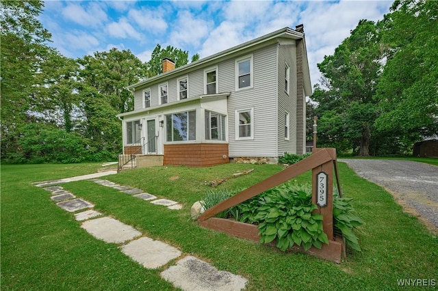 7395 W Somerset Rd, Somerset, NY 14008 - back of property featuring a chimney, a yard, gravel driveway, and entry steps