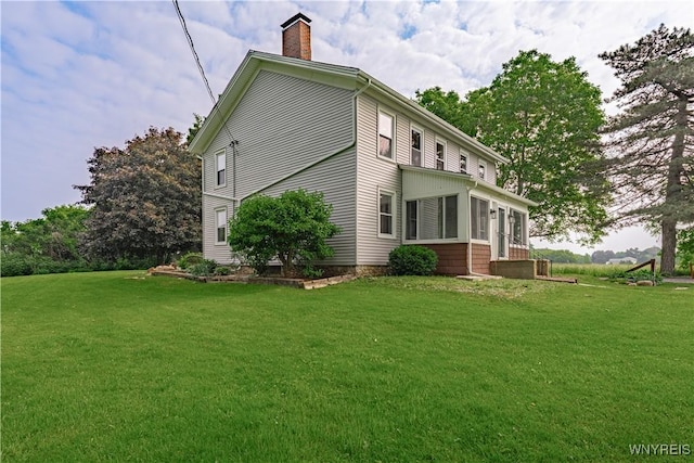 7395 W Somerset Rd, Somerset, NY 14008 - view of property exterior with a chimney, a sunroom, and a yard