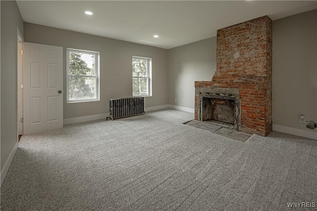 7395 W Somerset Rd, Somerset, NY 14008 - unfurnished living room with radiator, carpet floors, a brick fireplace, and recessed lighting