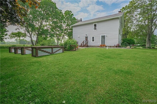 7395 W Somerset Rd, Somerset, NY 14008 - back of property with entry steps, a chimney, and a lawn
