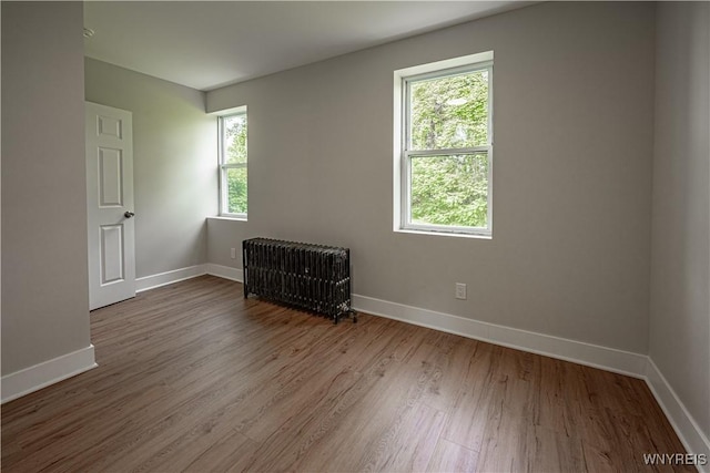 7395 W Somerset Rd, Somerset, NY 14008 - empty room with radiator and wood finished floors