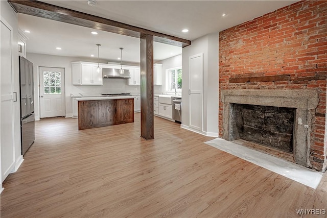 7395 W Somerset Rd, Somerset, NY 14008 - kitchen with ventilation hood, light wood-type flooring, open floor plan, appliances with stainless steel finishes, and white cabinets
