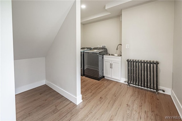 7395 W Somerset Rd, Somerset, NY 14008 - washroom with radiator, washer and clothes dryer, and light wood-style flooring