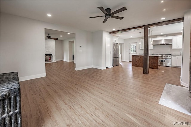 7395 W Somerset Rd, Somerset, NY 14008 - unfurnished living room with ceiling fan, light wood-type flooring, recessed lighting, and a large fireplace