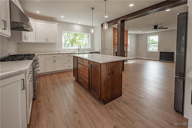 7395 W Somerset Rd, Somerset, NY 14008 - kitchen with wall chimney range hood, light wood-type flooring, white cabinets, recessed lighting, and a center island