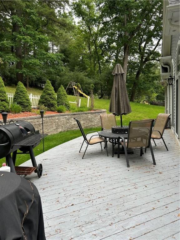 38 Hemlock Ln, Erwin, NY 14870 - deck featuring outdoor dining area, view of wooded area, and grilling area