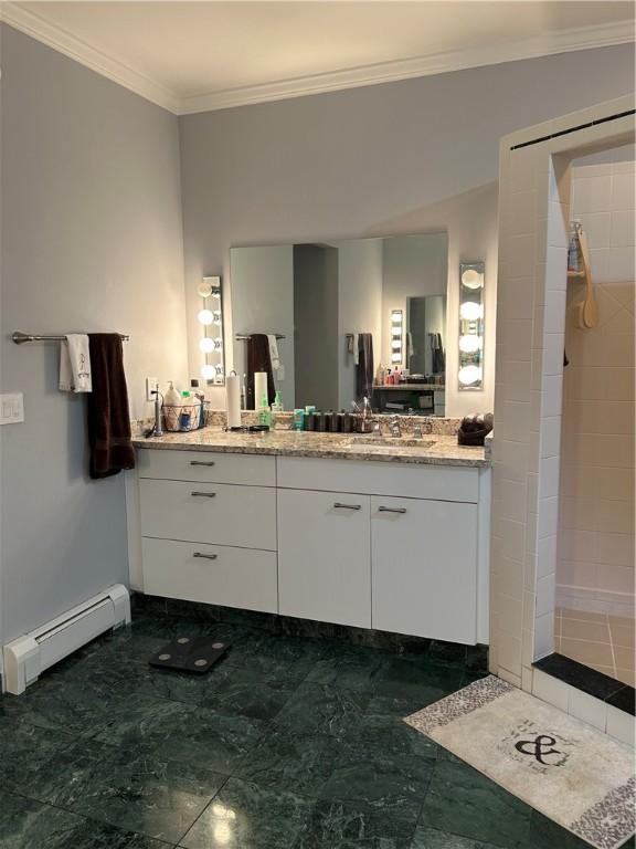 38 Hemlock Ln, Erwin, NY 14870 - bathroom featuring a baseboard heating unit, ornamental molding, vanity, marble finish floors, and a tile shower