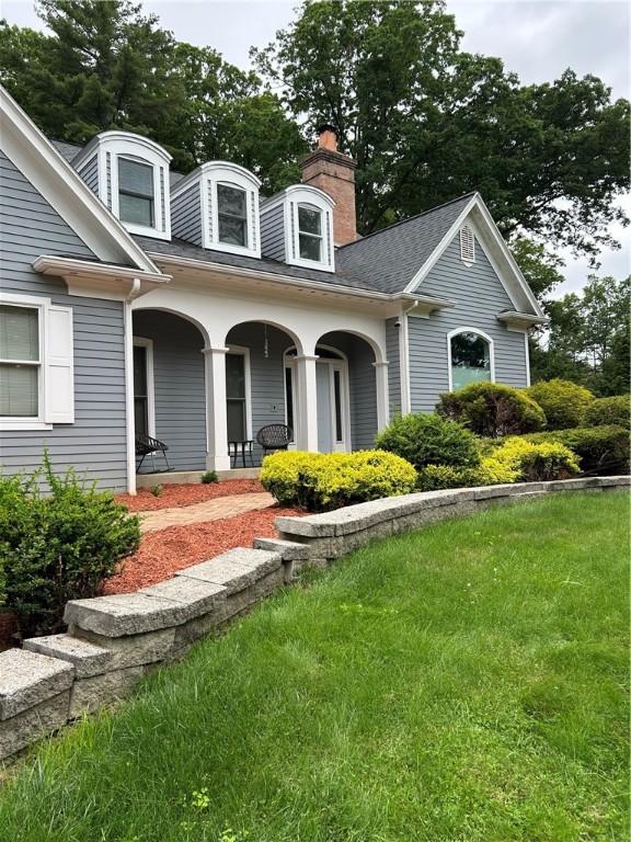 38 Hemlock Ln, Erwin, NY 14870 - view of front of property with covered porch, a shingled roof, a chimney, and a front yard