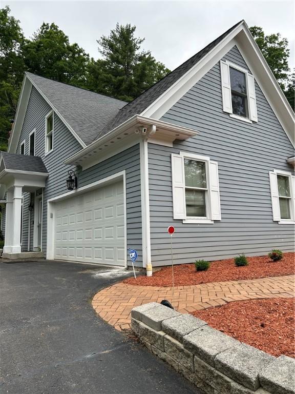 38 Hemlock Ln, Erwin, NY 14870 - view of side of property with an attached garage, driveway, and roof with shingles