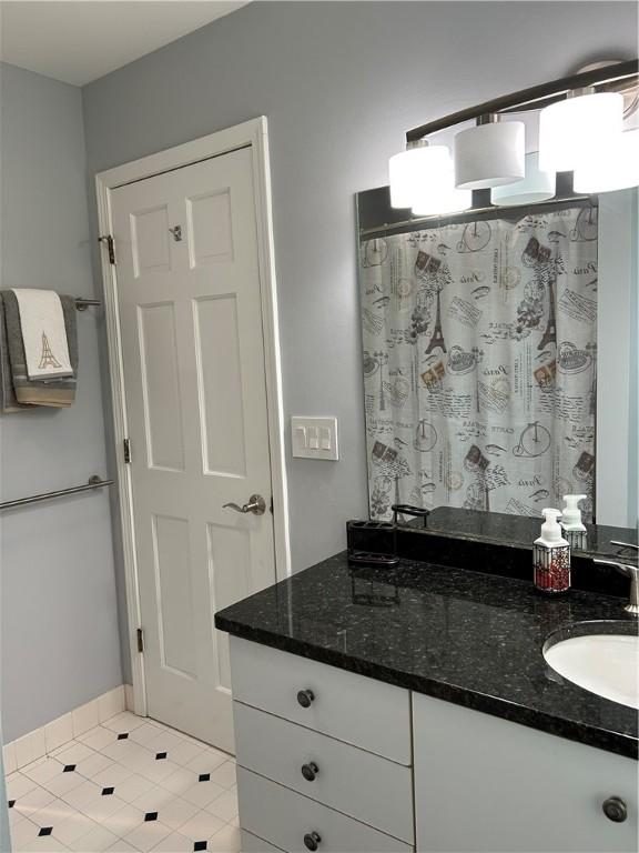 38 Hemlock Ln, Erwin, NY 14870 - full bath featuring double vanity, tile patterned floors, and a shower with shower curtain