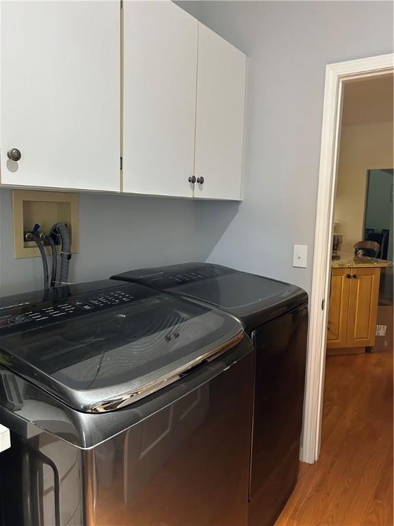 38 Hemlock Ln, Erwin, NY 14870 - washroom with light wood-style floors, washing machine and dryer, and cabinet space