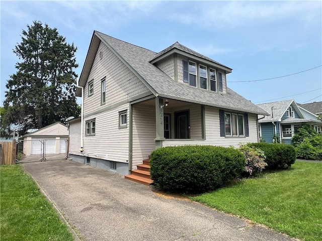 534 Mount Zoar St, Elmira-City, NY 14904 - view of front of property with an outdoor structure, a detached garage, a front yard, roof with shingles, and a porch
