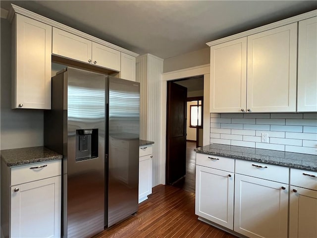 534 Mount Zoar St, Elmira-City, NY 14904 - kitchen featuring stainless steel fridge with ice dispenser, dark wood-style floors, white cabinetry, decorative backsplash, and dark stone countertops