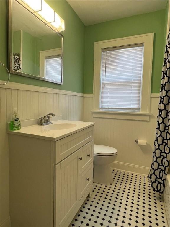 534 Mount Zoar St, Elmira-City, NY 14904 - bathroom featuring wainscoting, vanity, curtained shower, and tile patterned floors