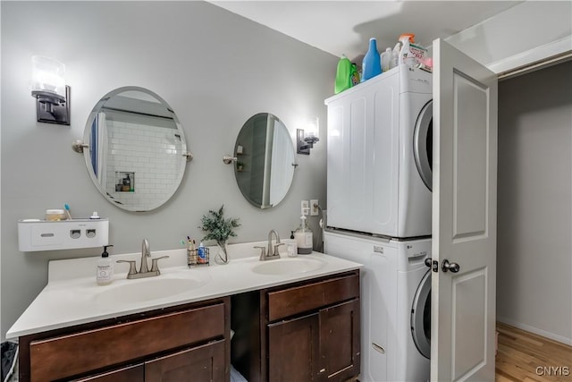 10256 State Route 26, Denmark, NY 13367 - full bath with stacked washer and clothes dryer, double vanity, and wood finished floors