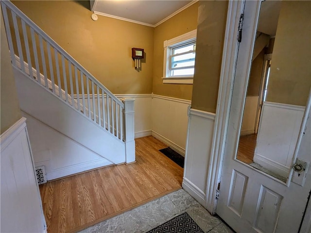 354 Euclid Ave, Elmira City, NY 14905 - stairs featuring a wainscoted wall, ornamental molding, and wood finished floors