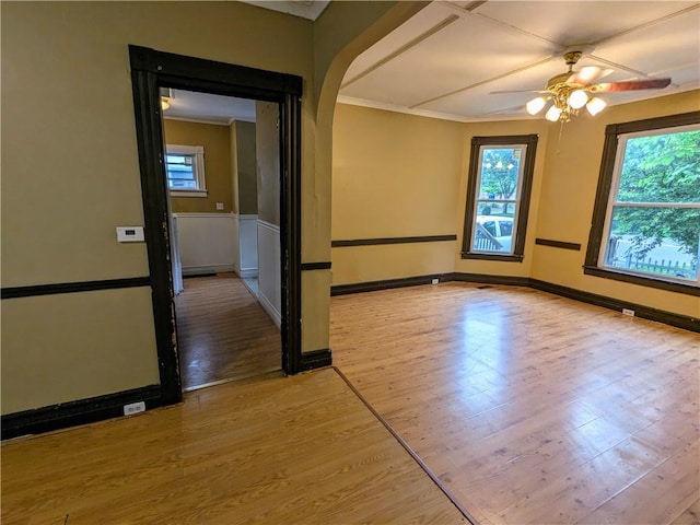354 Euclid Ave, Elmira City, NY 14905 - unfurnished room featuring wood finished floors, a ceiling fan, ornamental molding, and arched walkways