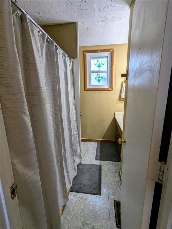 354 Euclid Ave, Elmira City, NY 14905 - bathroom featuring vanity, a textured ceiling, and curtained shower
