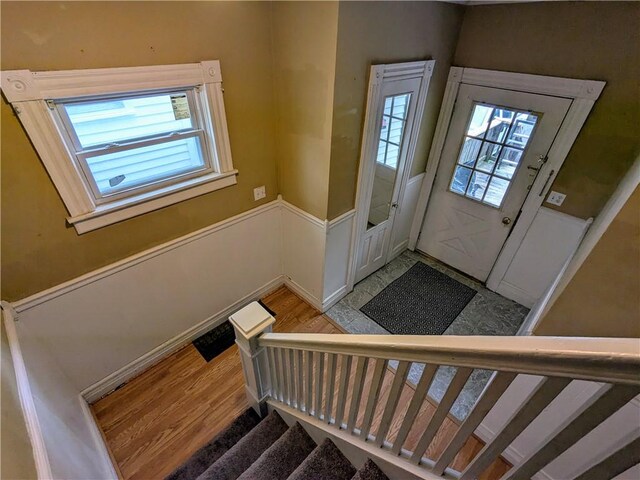 354 Euclid Ave, Elmira City, NY 14905 - foyer with plenty of natural light, stairway, light wood-style floors, and wainscoting