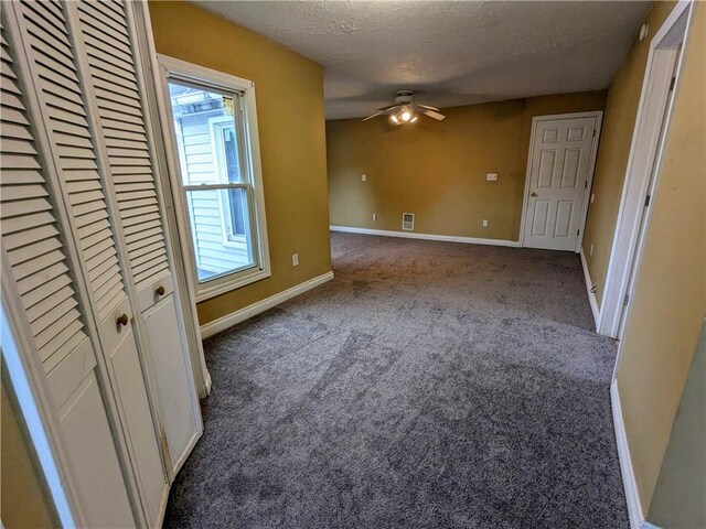 354 Euclid Ave, Elmira City, NY 14905 - unfurnished bedroom featuring a textured ceiling, carpet floors, multiple windows, and a closet