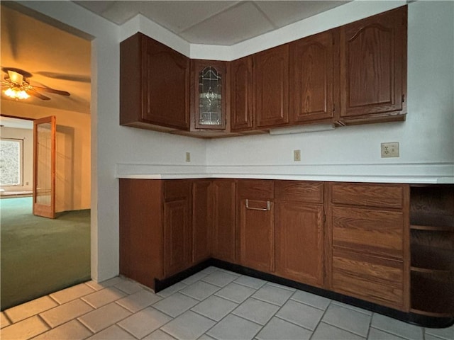 100 Brickwork Rd, Hamlin, PA 16735 - kitchen featuring light countertops, a ceiling fan, glass insert cabinets, light colored carpet, and light tile patterned flooring