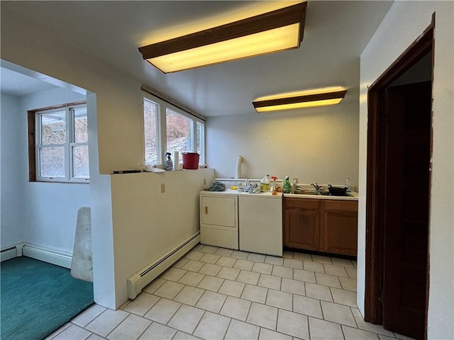 100 Brickwork Rd, Hamlin, PA 16735 - kitchen with a baseboard heating unit, washer and dryer, light tile patterned floors, and brown cabinetry