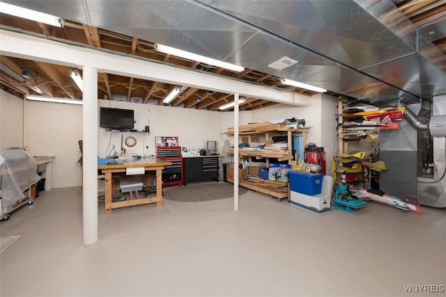 2371 Bullis Rd, Elma, NY 14059 - unfinished basement featuring a workshop area and heating unit