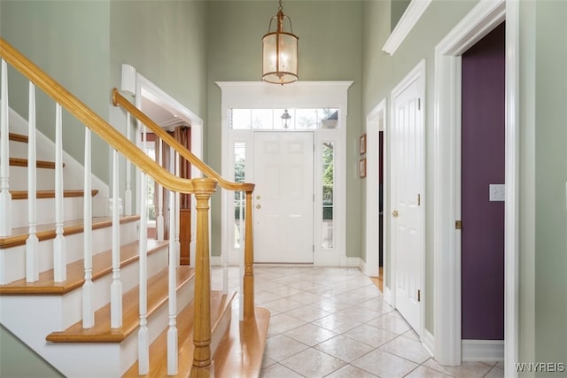 2371 Bullis Rd, Elma, NY 14059 - entrance foyer with a high ceiling, light tile patterned floors, and stairs
