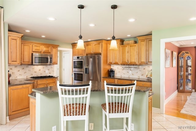2371 Bullis Rd, Elma, NY 14059 - kitchen with stainless steel appliances, light tile patterned floors, a kitchen island, tasteful backsplash, and recessed lighting