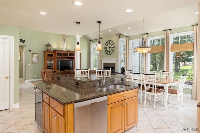 2371 Bullis Rd, Elma, NY 14059 - kitchen with dishwasher, open floor plan, a fireplace, light tile patterned flooring, and plenty of natural light