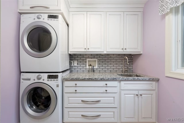2371 Bullis Rd, Elma, NY 14059 - laundry area with stacked washer and clothes dryer and cabinet space