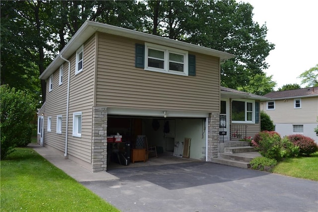 229 Everclay Dr, Greece, NY 14616 - split level home with a garage, stone siding, and driveway