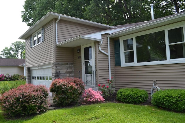 229 Everclay Dr, Greece, NY 14616 - view of front of house with an attached garage, stone siding, and a front lawn