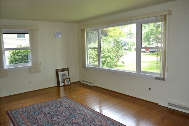 229 Everclay Dr, Greece, NY 14616 - unfurnished room featuring wood finished floors and a baseboard radiator