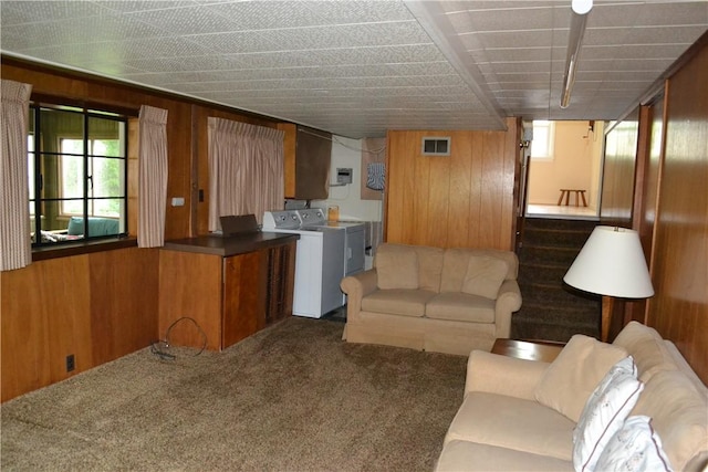 229 Everclay Dr, Greece, NY 14616 - living room featuring washer and clothes dryer, wooden walls, carpet floors, and stairs