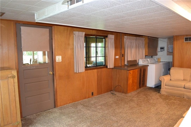 229 Everclay Dr, Greece, NY 14616 - kitchen featuring carpet, wooden walls, separate washer and dryer, open floor plan, and brown cabinetry