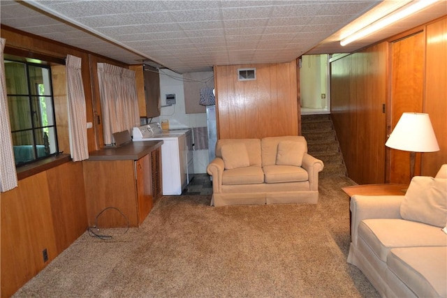 229 Everclay Dr, Greece, NY 14616 - carpeted living area with washer / dryer, wood walls, and stairway