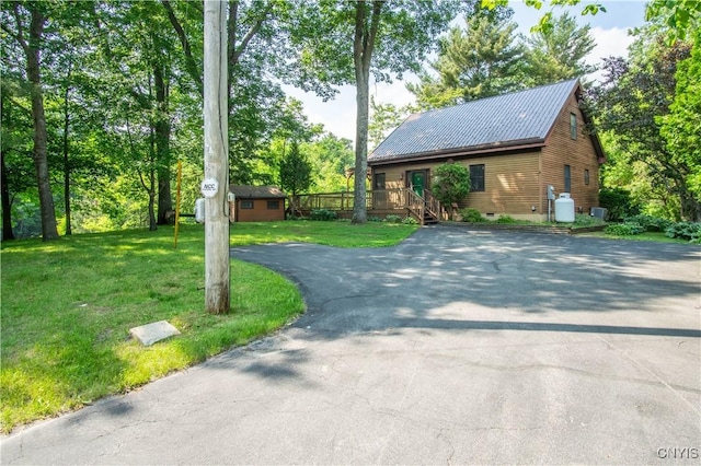 29591 Coon Bridge Rd, Theresa, NY 13691 - view of front of home featuring driveway, a front yard, a metal roof, and view of scattered trees