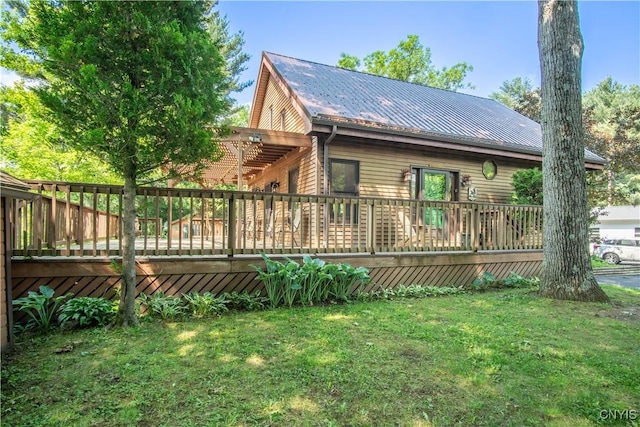29591 Coon Bridge Rd, Theresa, NY 13691 - back of house with a lawn, a wooden deck, and a metal roof