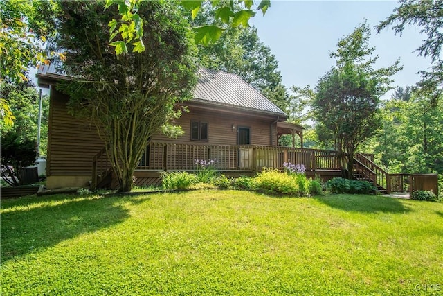 29591 Coon Bridge Rd, Theresa, NY 13691 - rear view of house featuring a lawn, a metal roof, and a deck