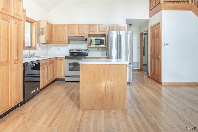 29591 Coon Bridge Rd, Theresa, NY 13691 - kitchen featuring stainless steel appliances, under cabinet range hood, light brown cabinets, light wood-style flooring, and high vaulted ceiling